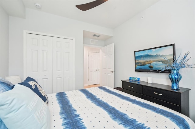 bedroom with a ceiling fan, visible vents, and a closet