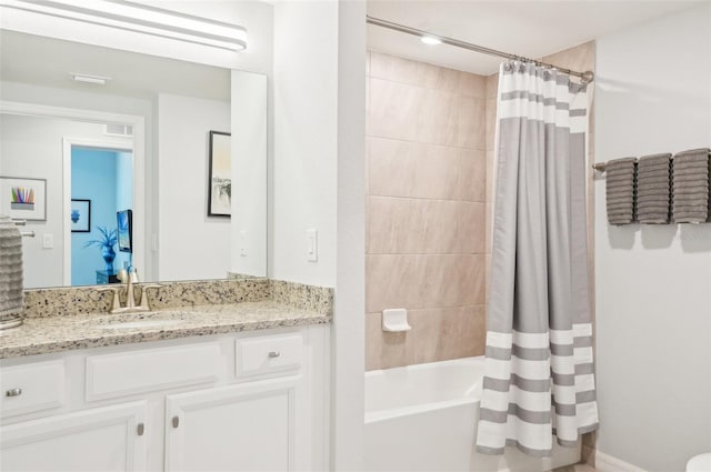 bathroom featuring shower / bath combo, vanity, and visible vents