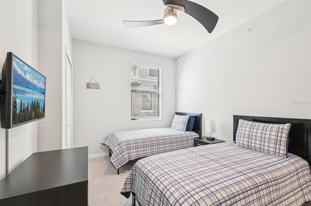 carpeted bedroom featuring ceiling fan and baseboards