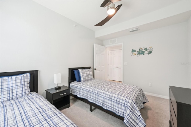 bedroom featuring baseboards, a ceiling fan, visible vents, and light colored carpet