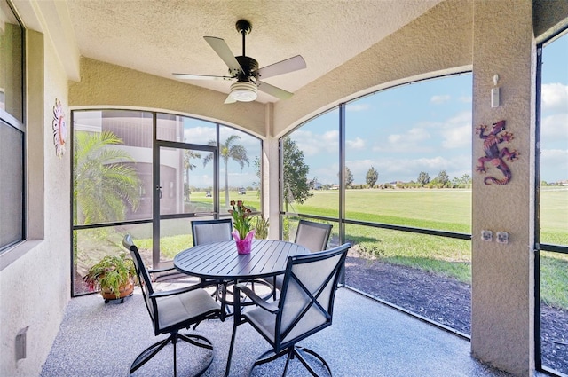 sunroom / solarium featuring a ceiling fan