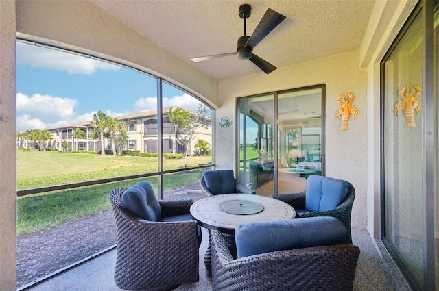 sunroom / solarium featuring ceiling fan