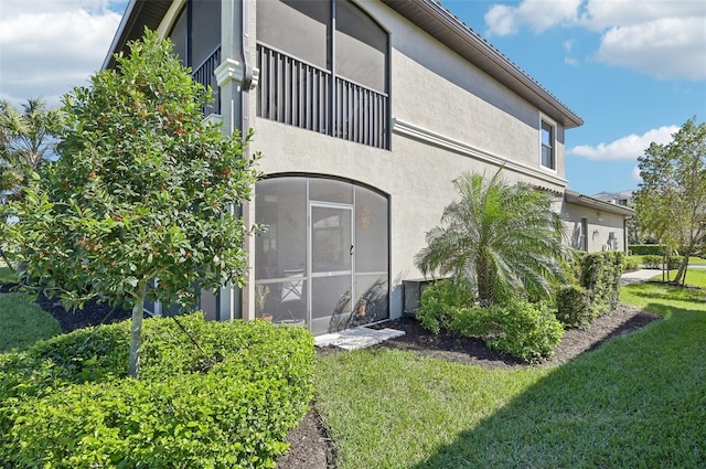 exterior space featuring a yard and stucco siding