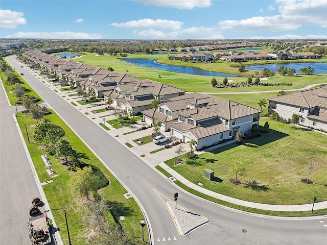 bird's eye view with view of golf course, a water view, and a residential view