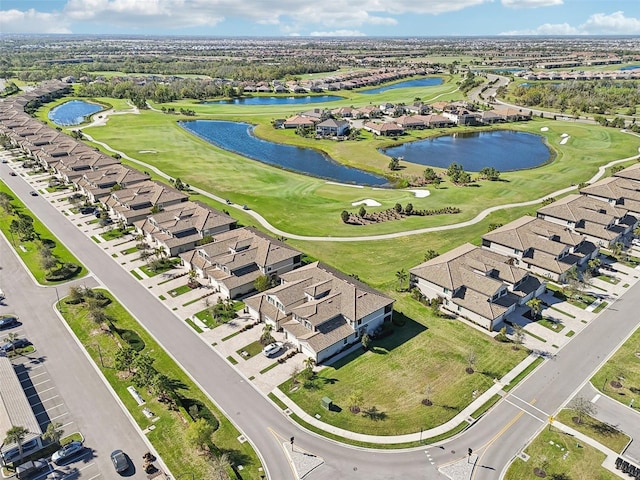 aerial view featuring golf course view, a water view, and a residential view