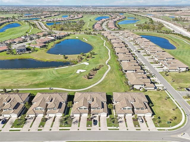 aerial view with a water view, view of golf course, and a residential view