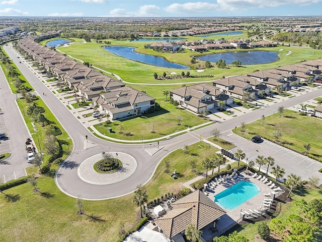 aerial view with view of golf course, a water view, and a residential view