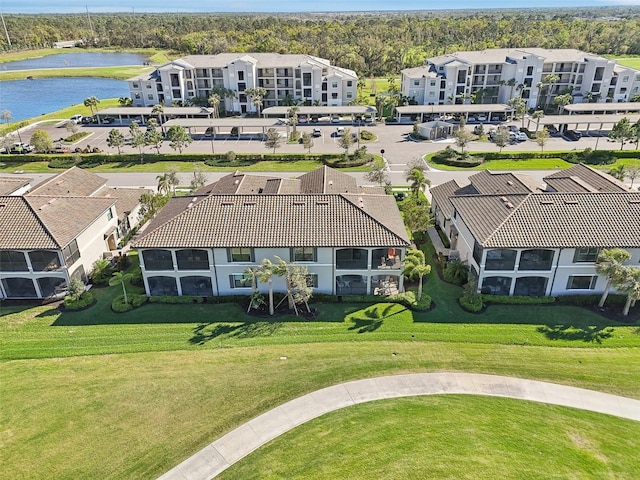 drone / aerial view with a water view and a residential view