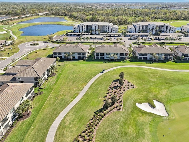 birds eye view of property featuring a water view, view of golf course, and a residential view