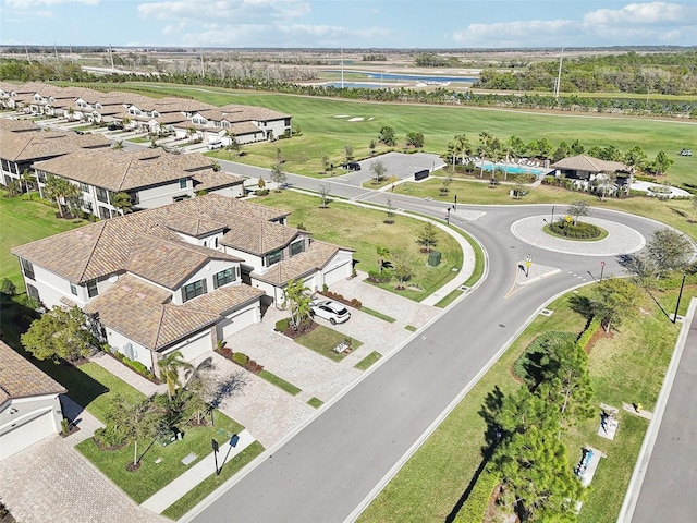 birds eye view of property featuring golf course view, a water view, and a residential view