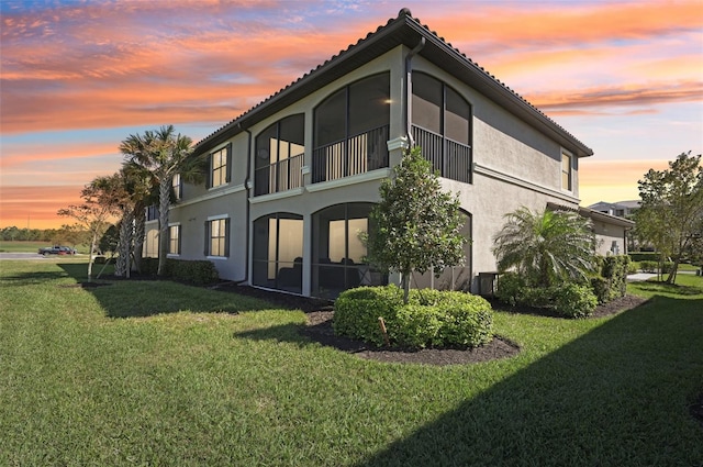 exterior space featuring a lawn and stucco siding