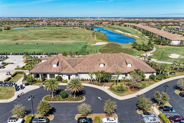 bird's eye view featuring view of golf course and a water view