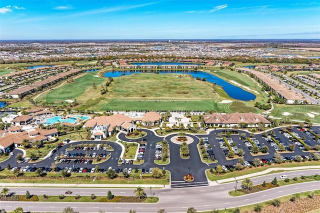 birds eye view of property featuring golf course view and a water view