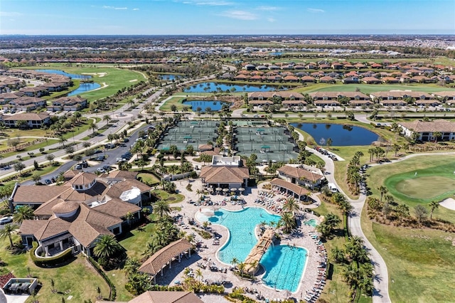 aerial view with a residential view, view of golf course, and a water view