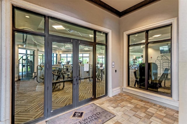 entrance to property featuring stucco siding and french doors