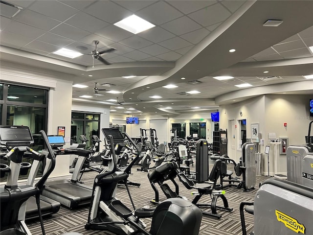 workout area featuring a paneled ceiling, carpet, visible vents, and a ceiling fan