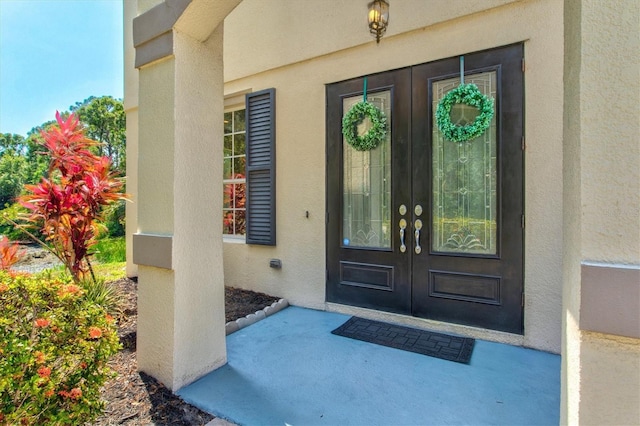 6156 41st St E, Bradenton, FL 34203 - entrance to property featuring french doors and stucco siding