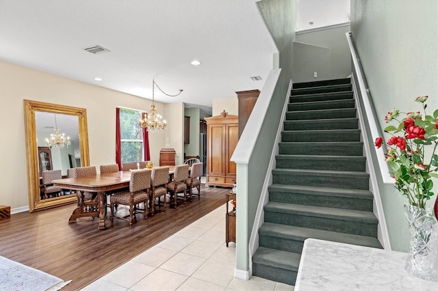 6156 41st St E, Bradenton, FL 34203 - stairs featuring a chandelier, wood finished floors, and recessed lighting