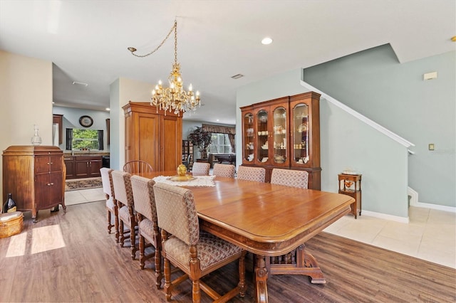 6156 41st St E, Bradenton, FL 34203 - dining area featuring a chandelier, stairway, light wood-style floors, and recessed lighting