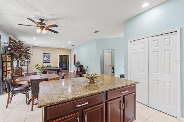 6156 41st St E, Bradenton, FL 34203 - kitchen featuring light tile patterned floors, a ceiling fan, light stone counters, billiards table, and a center island