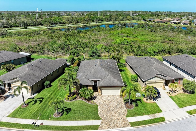 birds eye view of property with a water view and a residential view