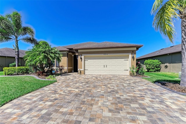 view of front of home with an attached garage, a front yard, decorative driveway, and stucco siding