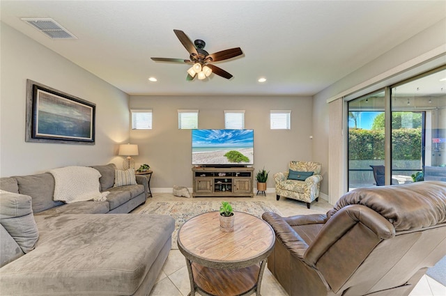 living area featuring baseboards, visible vents, a wealth of natural light, and recessed lighting