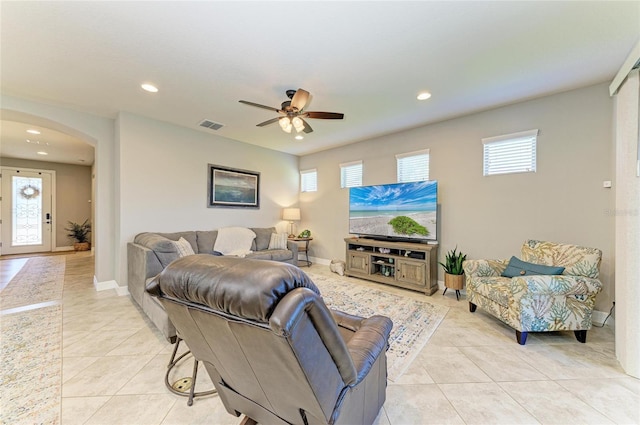 living area with a wealth of natural light, arched walkways, visible vents, and recessed lighting