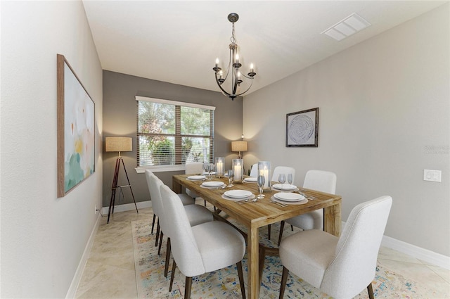 dining room with an inviting chandelier, baseboards, light tile patterned floors, and visible vents