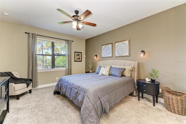 bedroom featuring light carpet, baseboards, and a ceiling fan