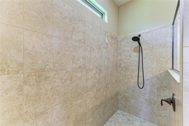 bathroom with a tile shower