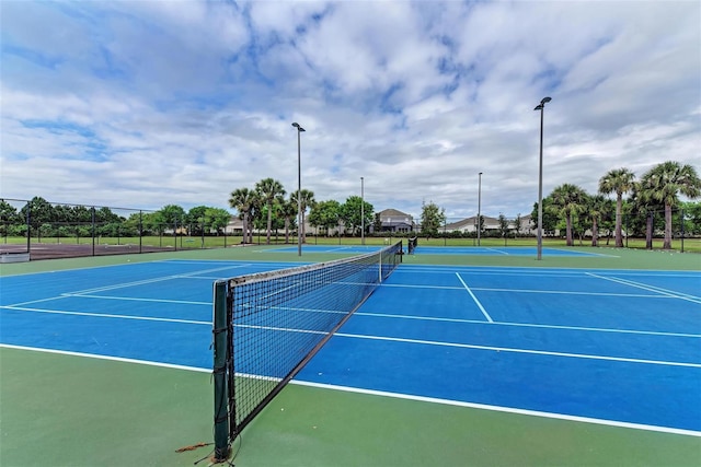 view of tennis court with fence