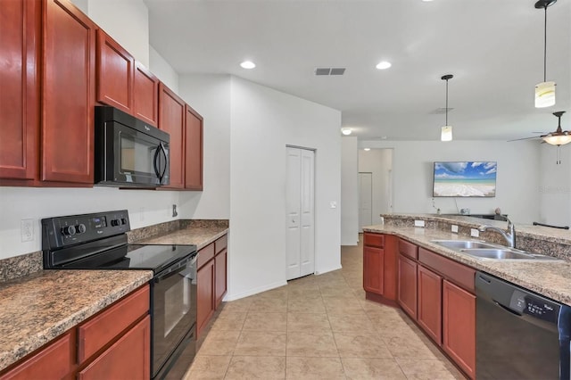 kitchen featuring dark brown cabinets, hanging light fixtures, ceiling fan, a sink, and black appliances
