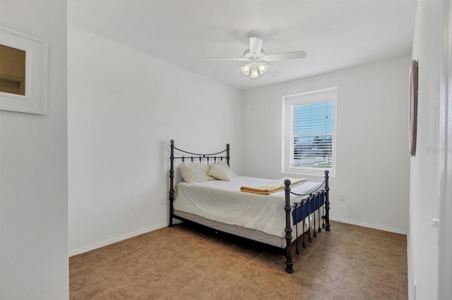 bedroom featuring baseboards, a ceiling fan, and tile patterned floors