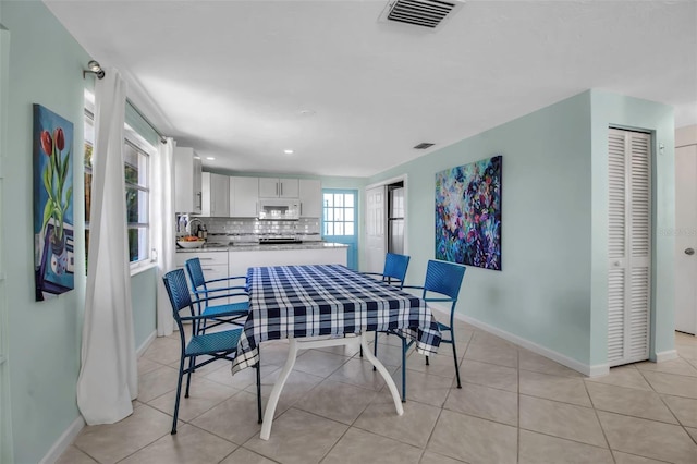 dining room featuring visible vents, baseboards, and light tile patterned floors