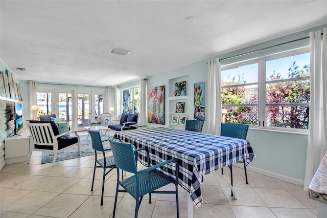 dining room featuring light tile patterned floors, french doors, visible vents, and baseboards