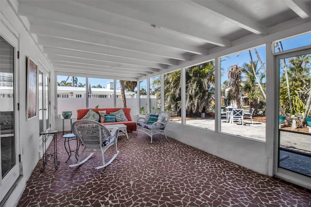 sunroom / solarium with a wealth of natural light and beam ceiling