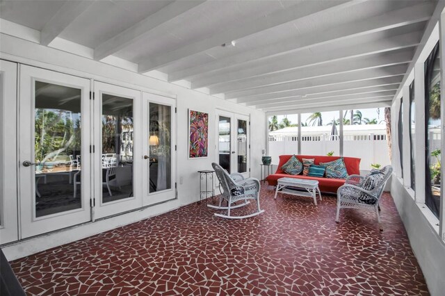 sunroom / solarium with beam ceiling and french doors