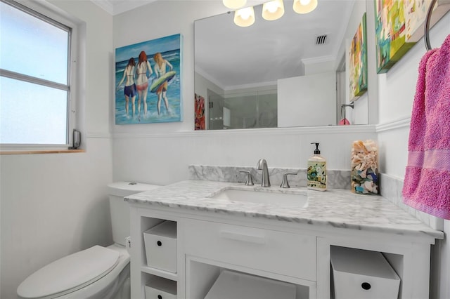 bathroom featuring ornamental molding, visible vents, vanity, and toilet