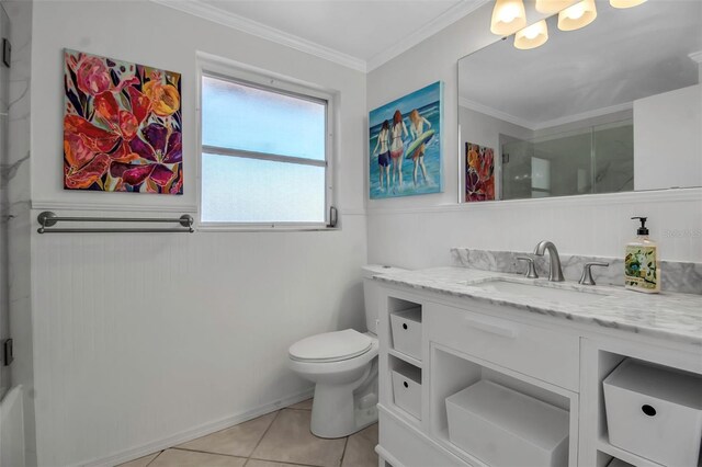 full bathroom featuring toilet, vanity, a shower with door, and crown molding