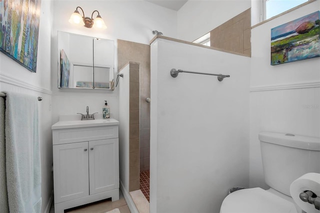 bathroom featuring a walk in shower, vanity, and toilet