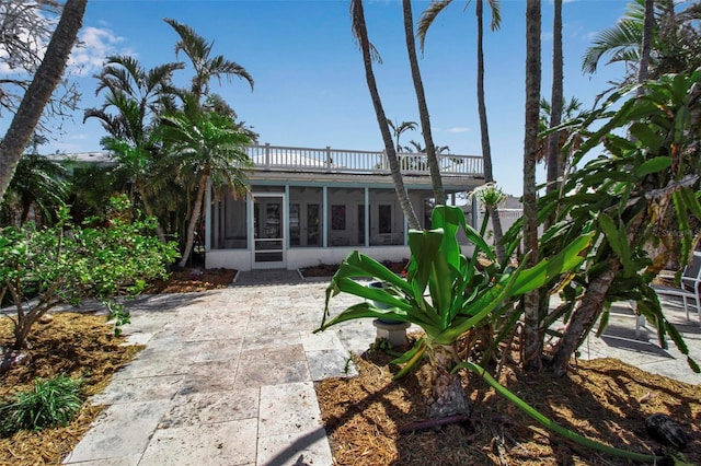 rear view of property with a sunroom