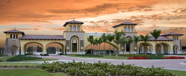 exterior space featuring stucco siding, driveway, and a tile roof