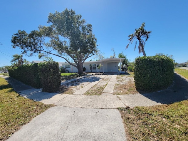 view of front of home featuring driveway and a carport