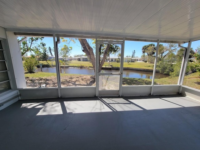 unfurnished sunroom with a water view