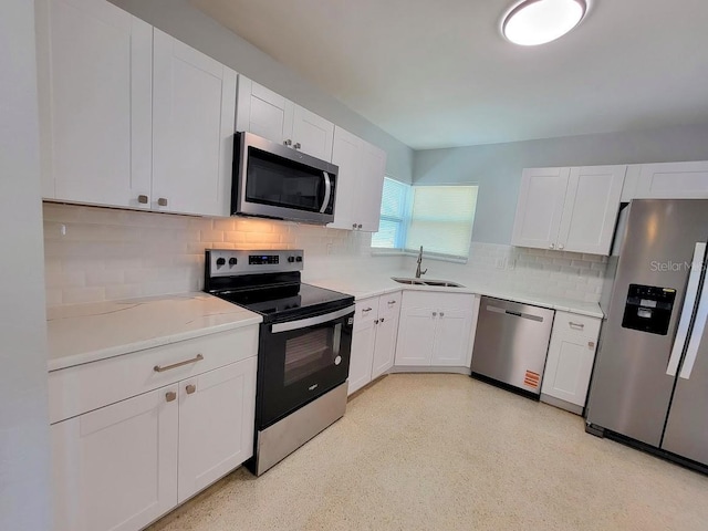 kitchen featuring white cabinetry, appliances with stainless steel finishes, light countertops, and a sink