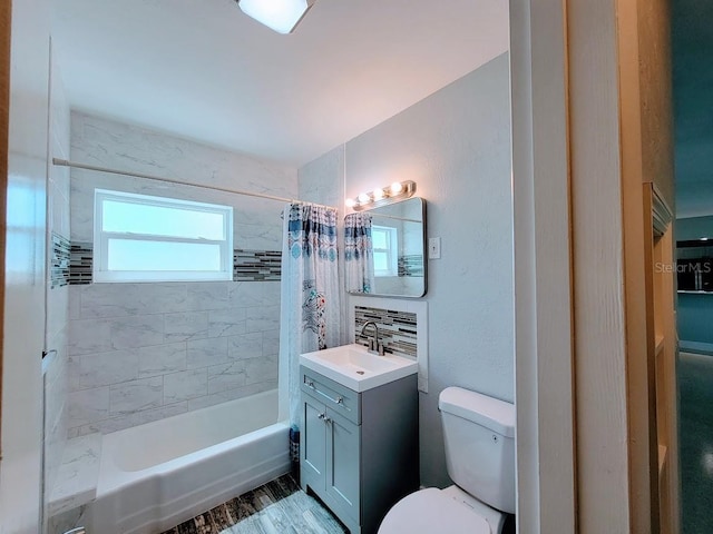 bathroom featuring vanity, toilet, and shower / tub combo with curtain