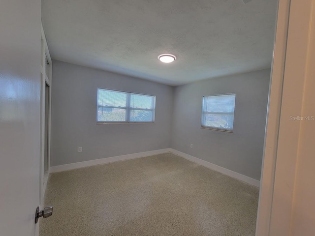 unfurnished room featuring baseboards