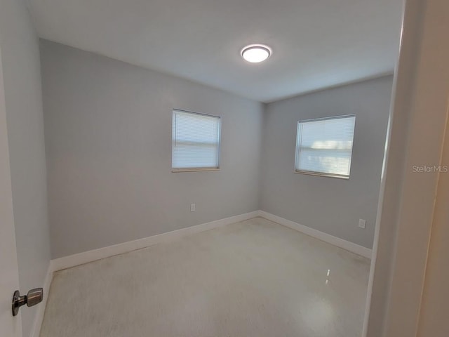 spare room featuring baseboards