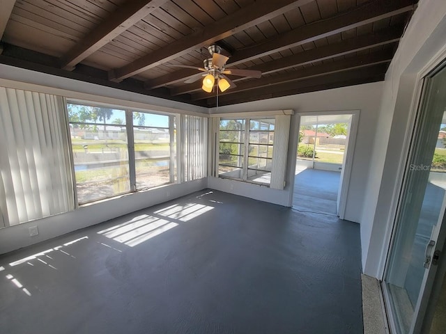 unfurnished sunroom with wood ceiling, ceiling fan, and beamed ceiling